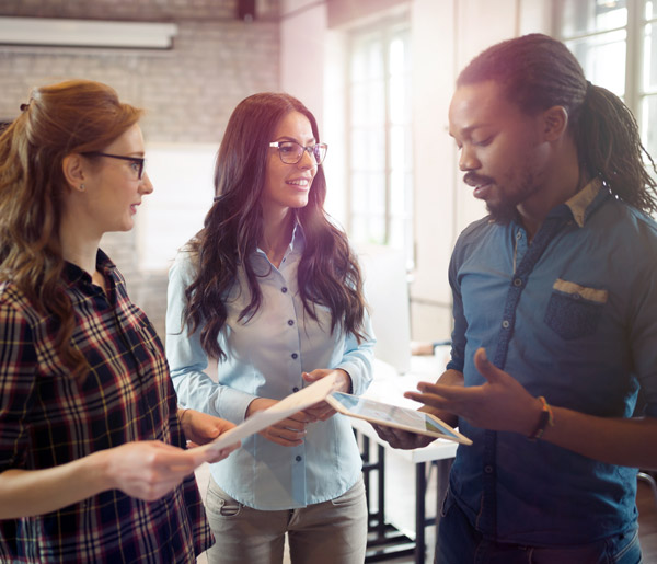 Managed IT services in San Diego with three employees discussing work
